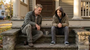 A teenager and a parent sitting on outdoor steps having a serious, calm conversation